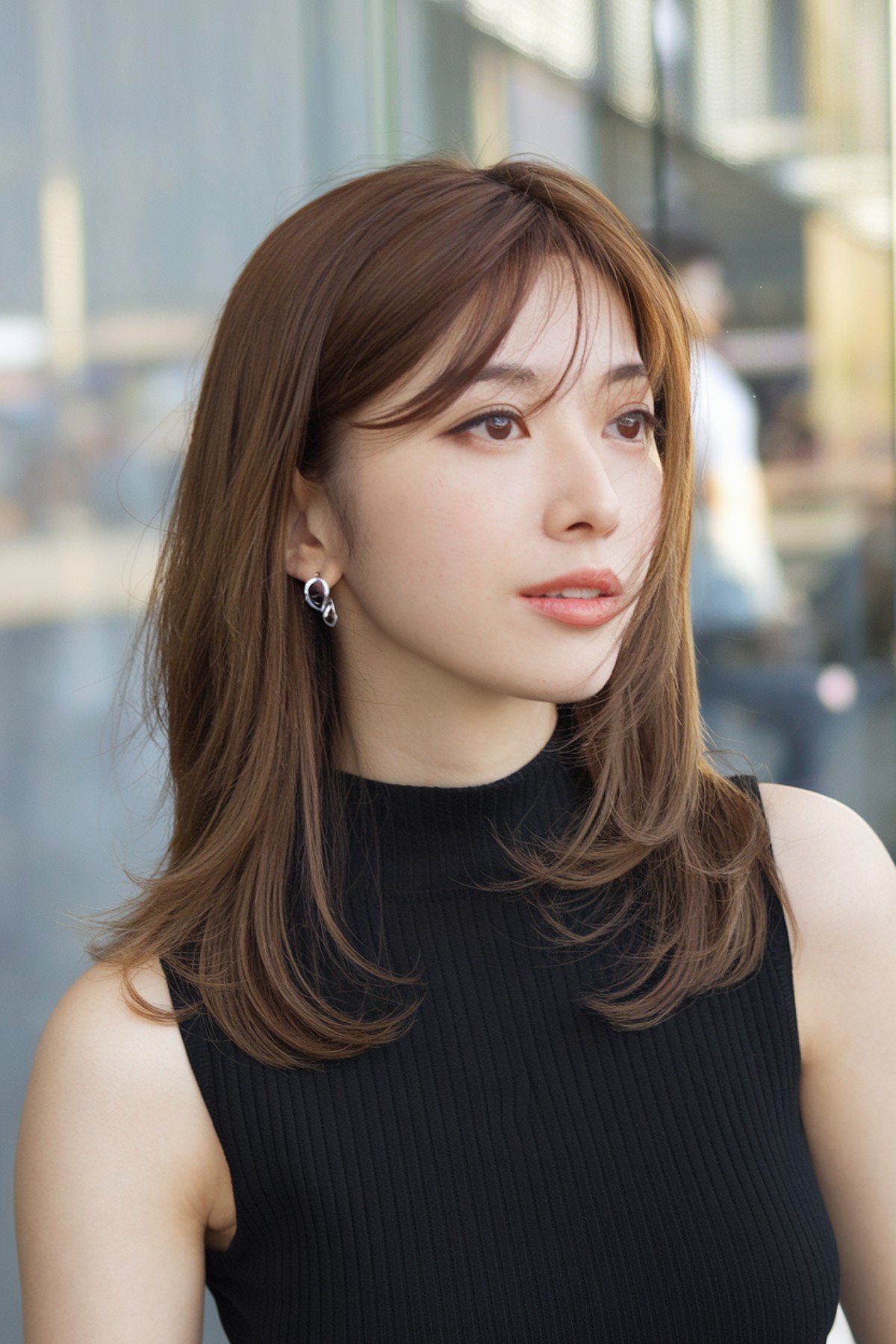 Layered haircut for Japanese women with wispy layers and airy bangs