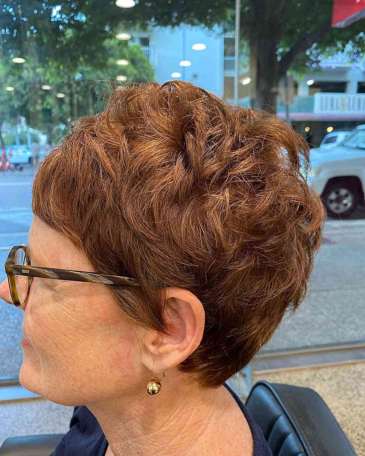 Modern Layered Pixie Crop with Micro Bangs for women aged 60 with pair of glasses