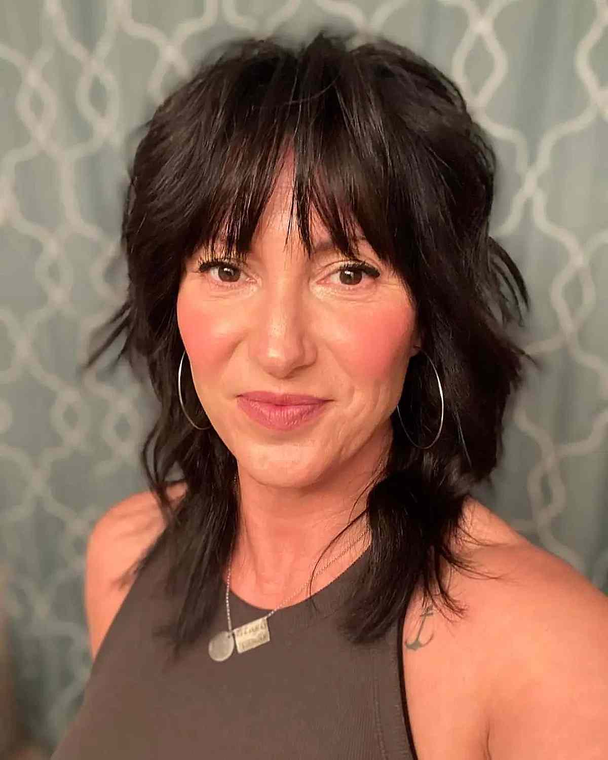 Modern Mullet Shag with Piece-y Bangs for Ladies in Their Forties