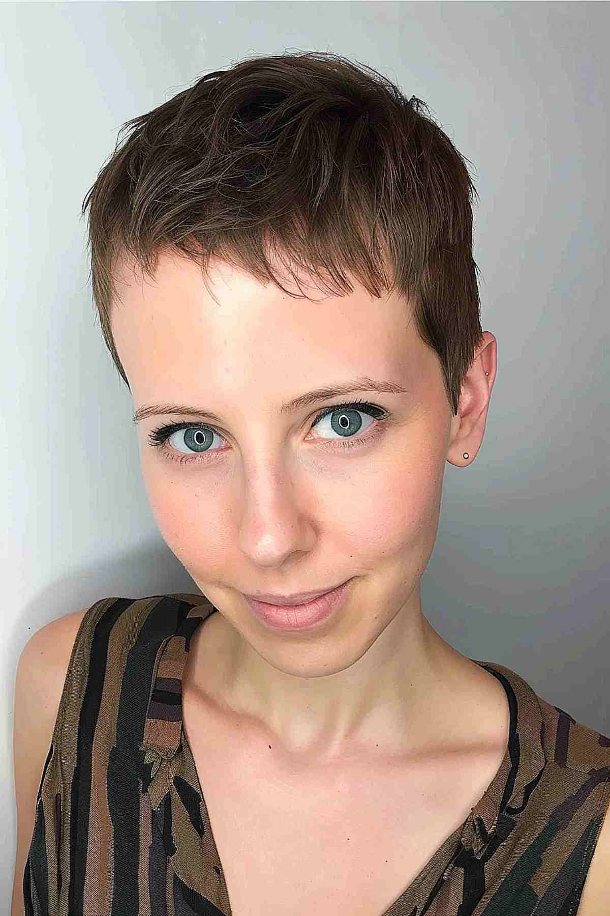 Modern disconnected pixie cut with textured top and short bangs.