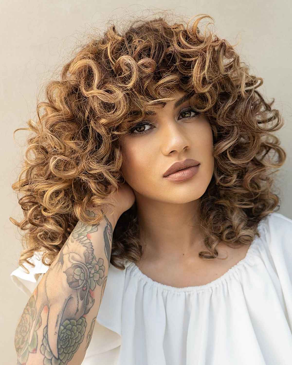 adorable bangs on medium-length curly hair