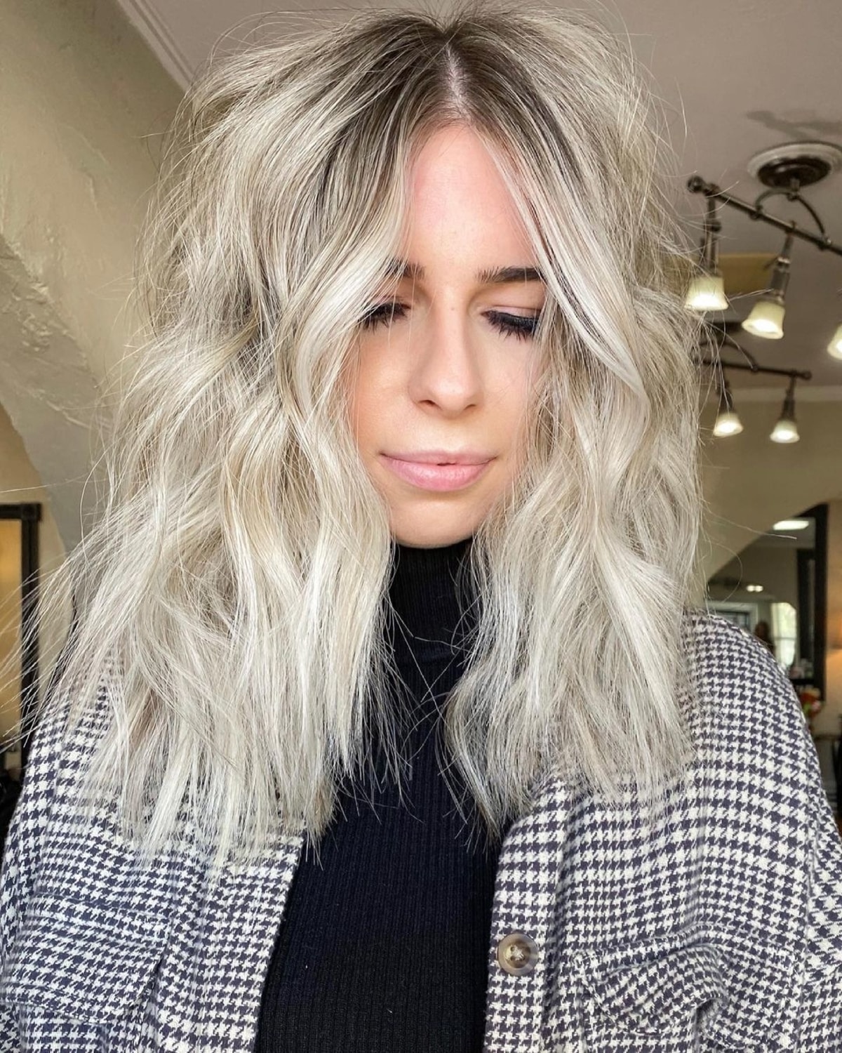 An Elegant Center Part Shag with Textured Layers and Platinum Tones