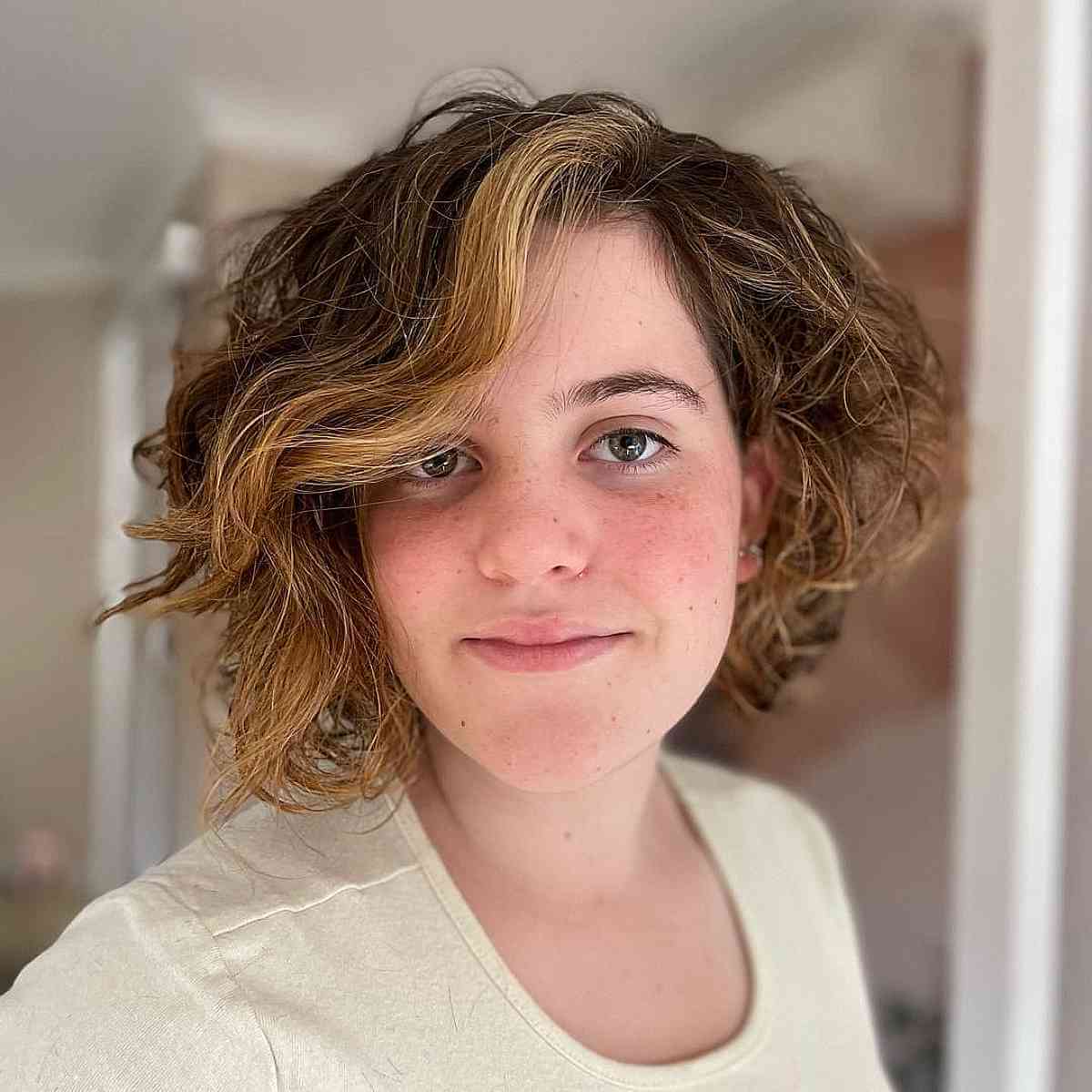 Asymmetrical Bob with Chin-Length Tousled Curls for Oval Faces