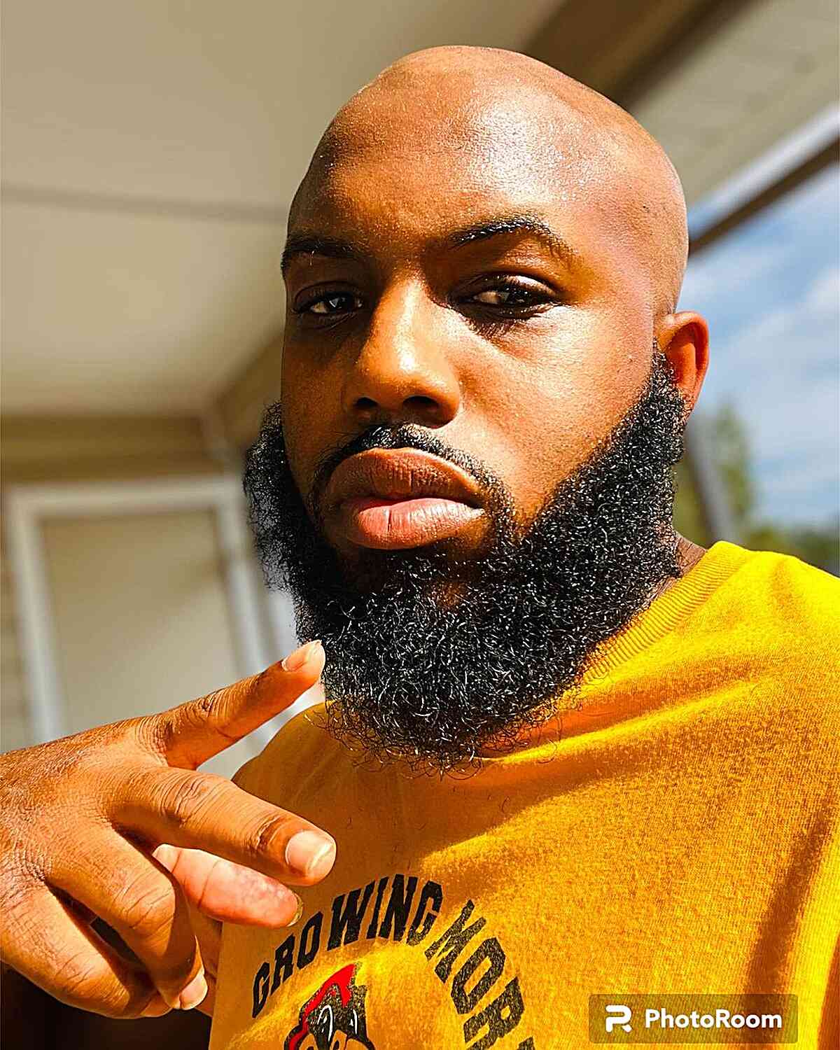 Bald Cut Paired with a Long Beard for Black Men