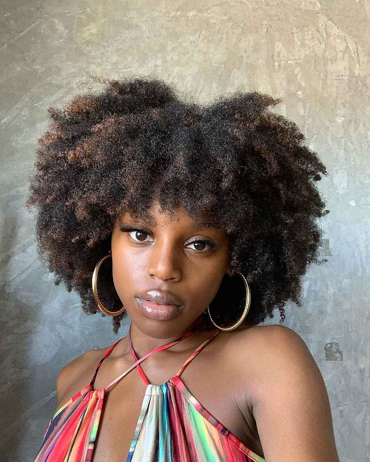 Afro-textured hair featuring bangs