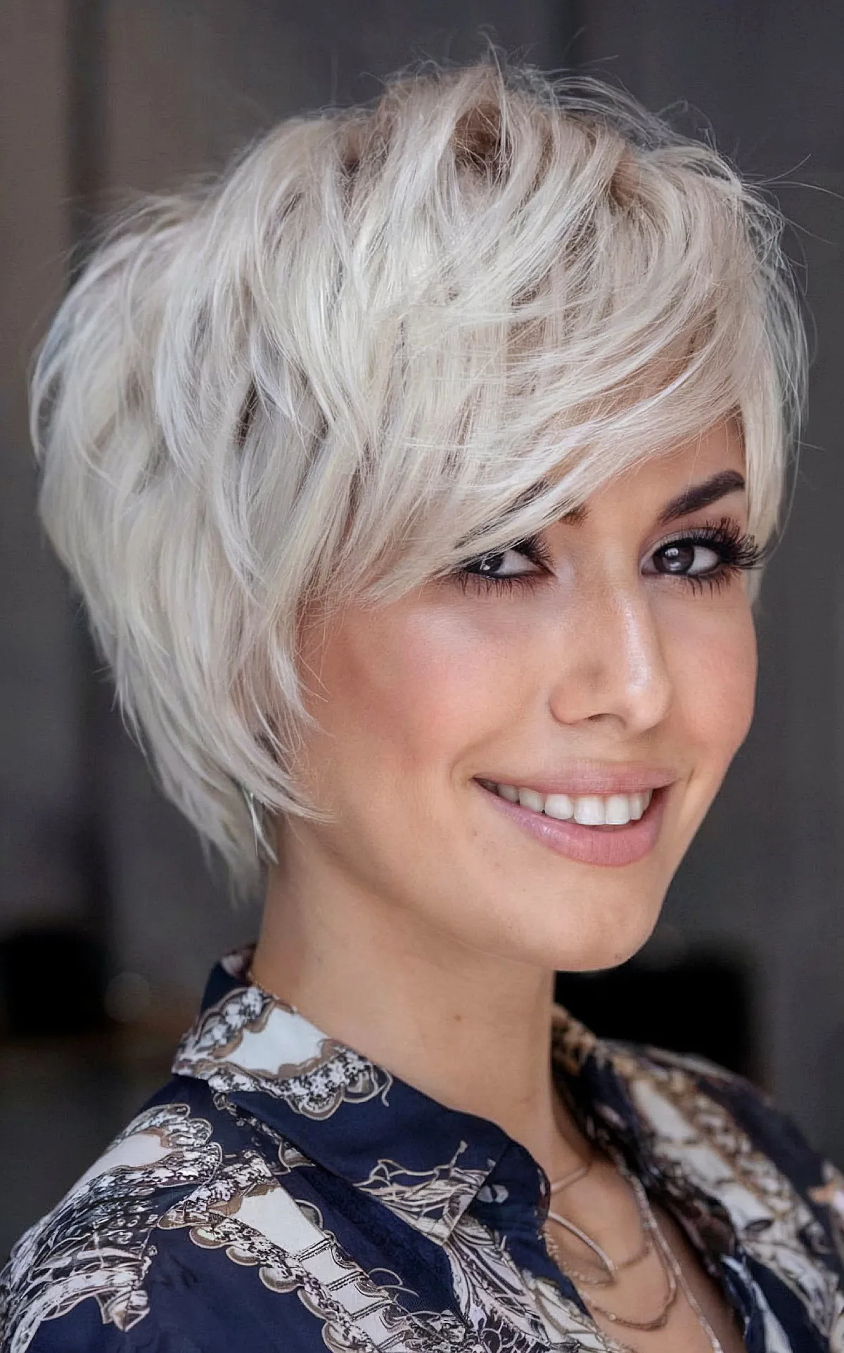 Beautiful Short Blonde Feathered Hairstyle with Side-Swept Bangs