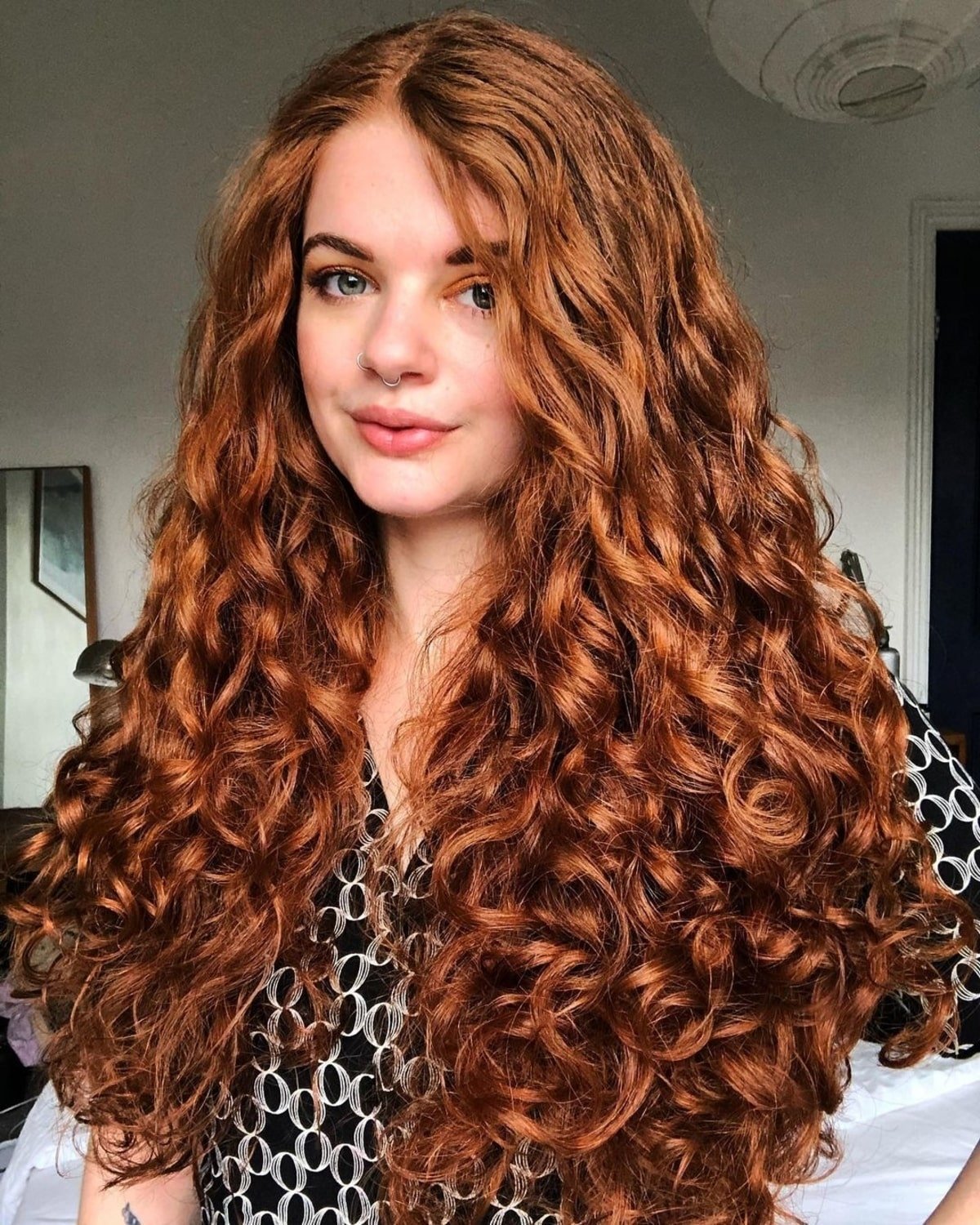 Beautiful long red curly hairstyle featuring voluminous curls