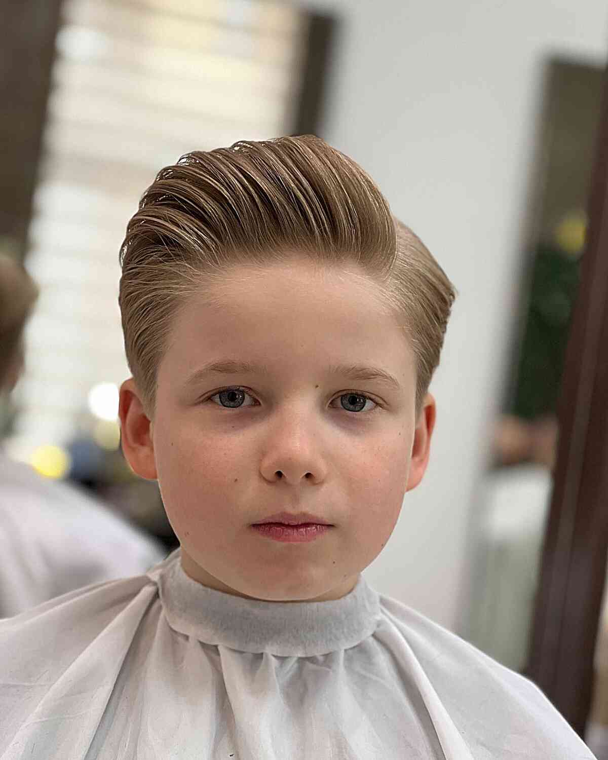 Blonde Brushed Back Haircut with Hard Part for Boys featuring straight hair