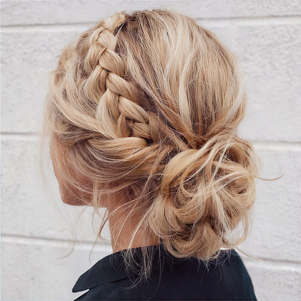 Boho-Inspired Messy Bun with a Stylish Side Braid