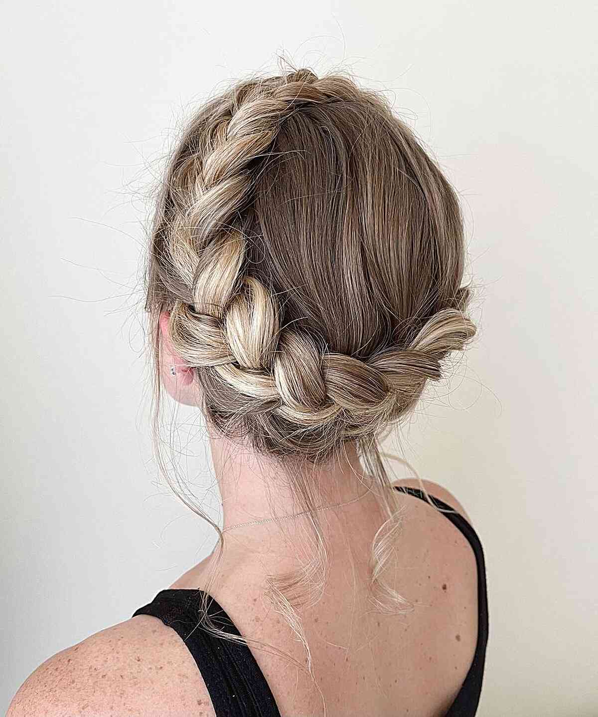 Elegant Updo with Braided Crown and Flowing Wavy Tresses for Long Hair