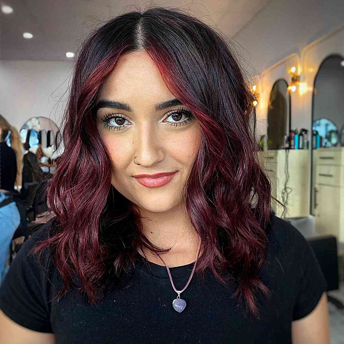 Burgundy Highlights That Frame the Face for Black Hair Styled with Center Part and Waves