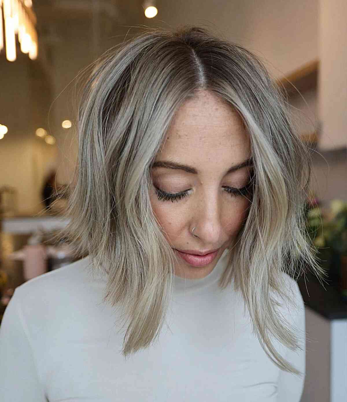 Center-Parted Choppy Inverted Bob with Light Blonde Highlights