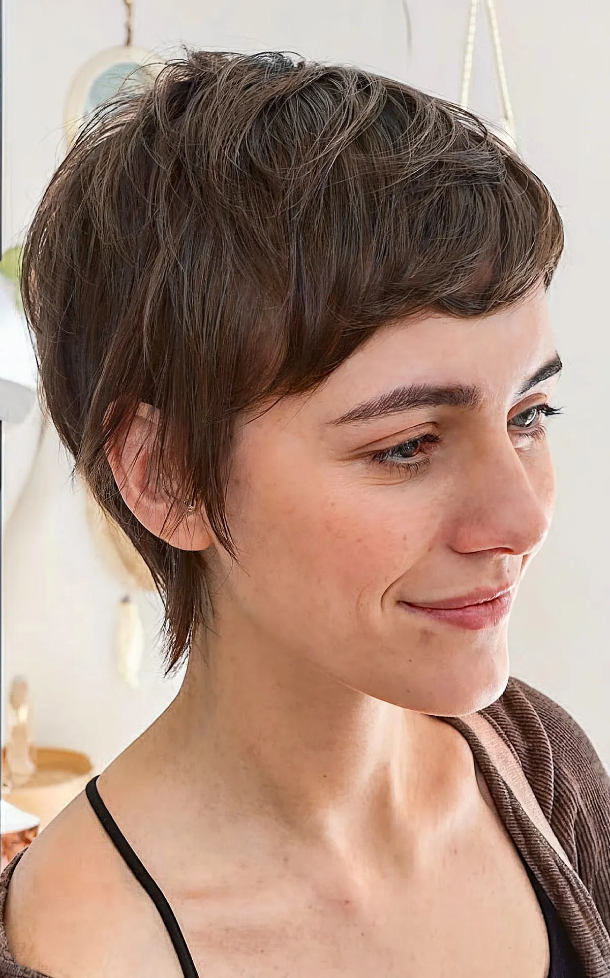 Charming Brunette Pixie with Side-Swept Bangs for Fine Hair