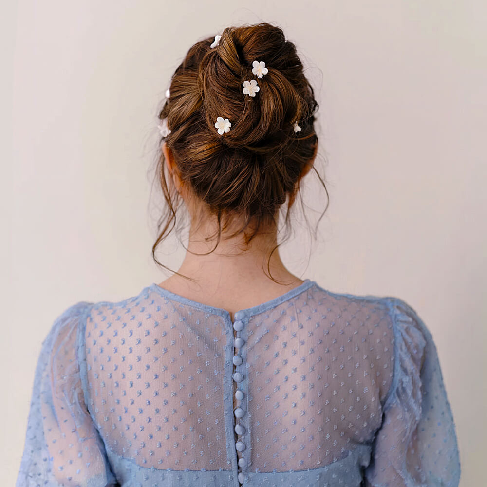Charming Bun Updo Adorned with Floral Pins