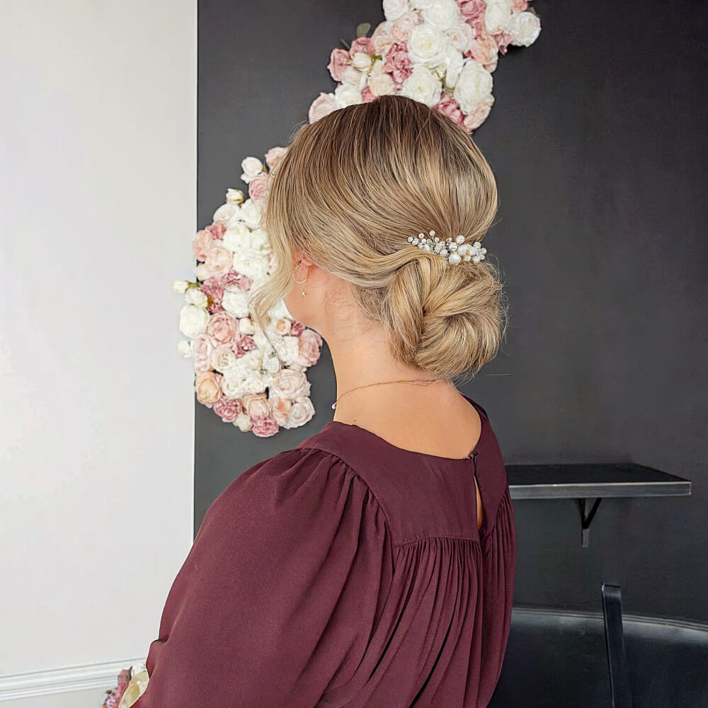 Charming Low Loose Bun with Pearl Accessories for Prom Night