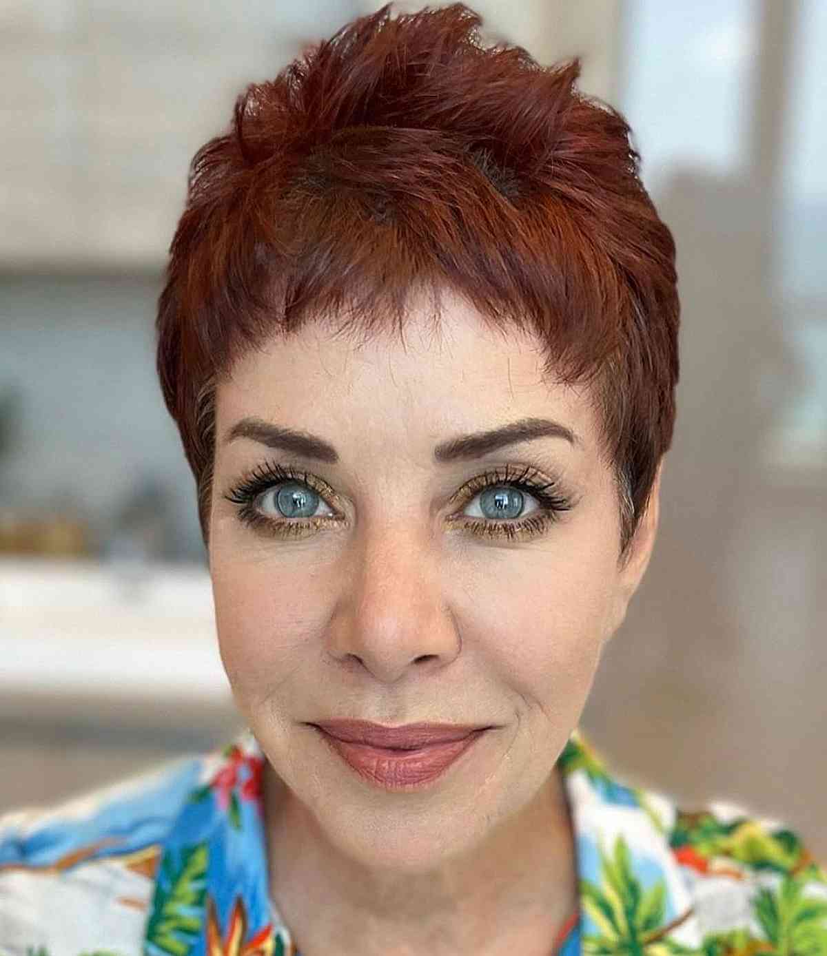 Charming Red Pixie Cut with Baby Bangs for Ladies Over Fifty with Thin Hair