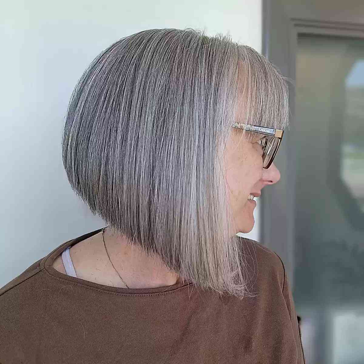 Neck-Length Angled Inverted Grey Bob with Bangs on Older Ladies