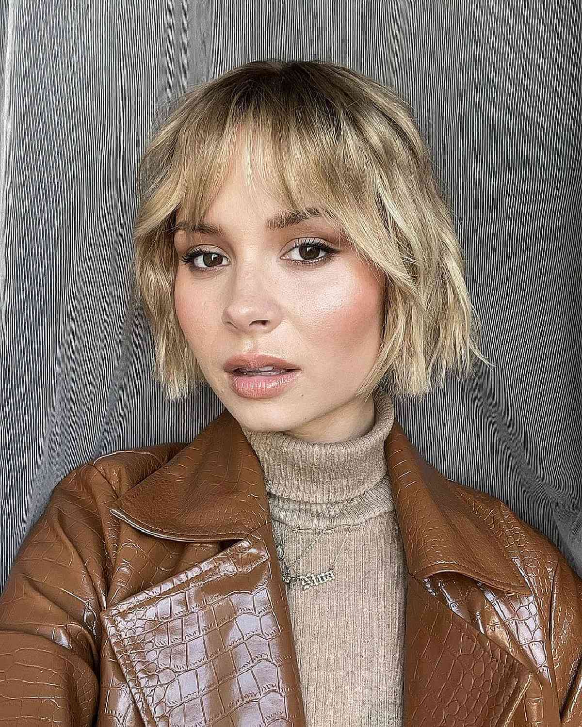 Chic Blonde Bob with Gentle Beach Waves and Wispy Fringe