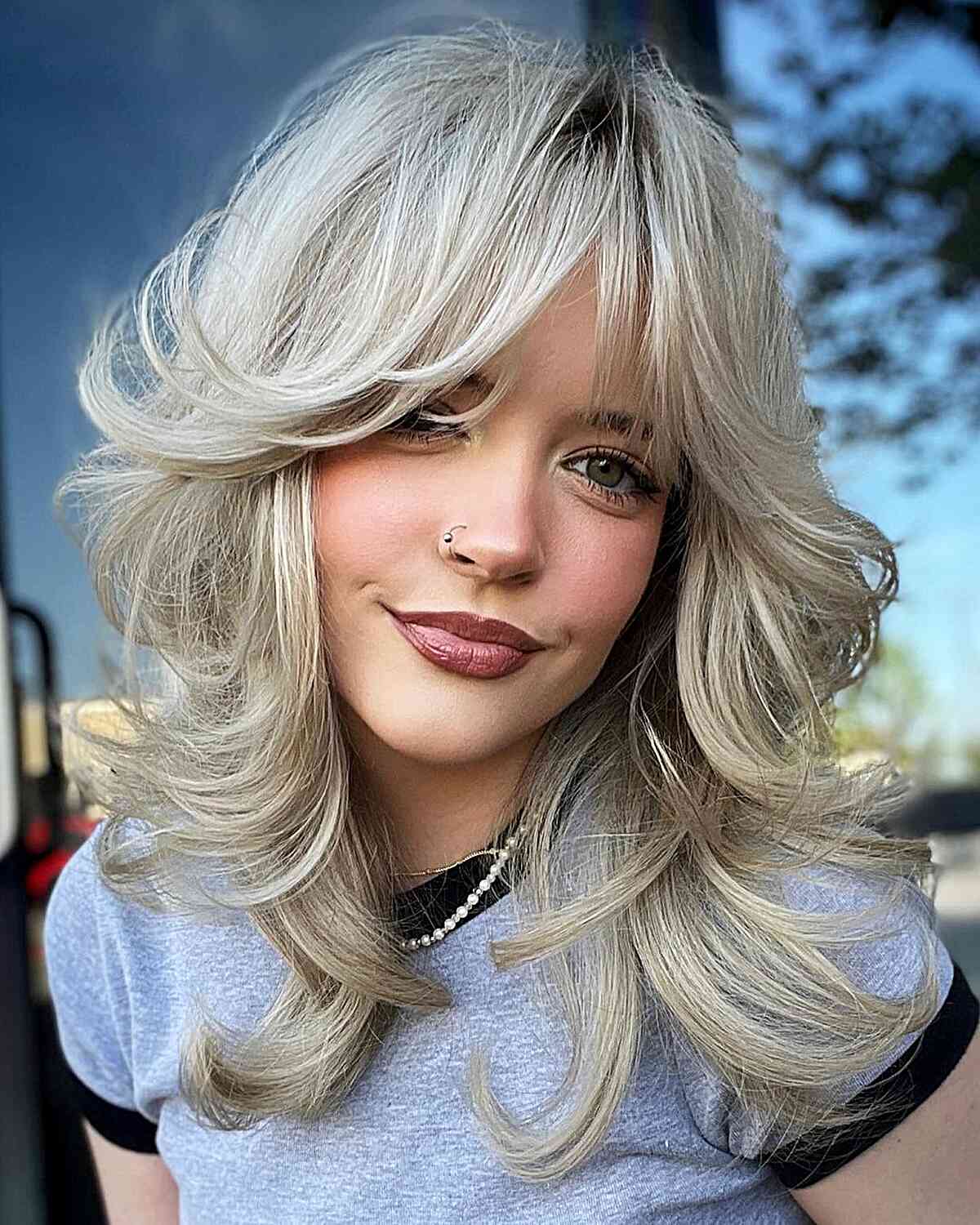 Medium-Length Blonde Shag featuring Ample Volume and Bangs for women in their 30s with style