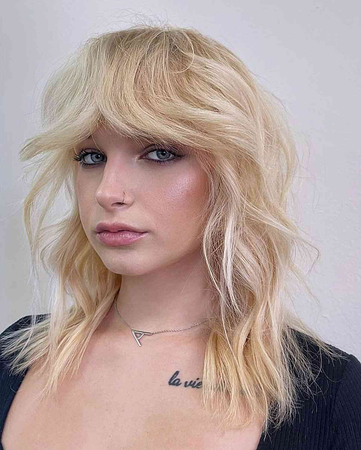 Chic Blonde Shag with Bold Curtain Bangs