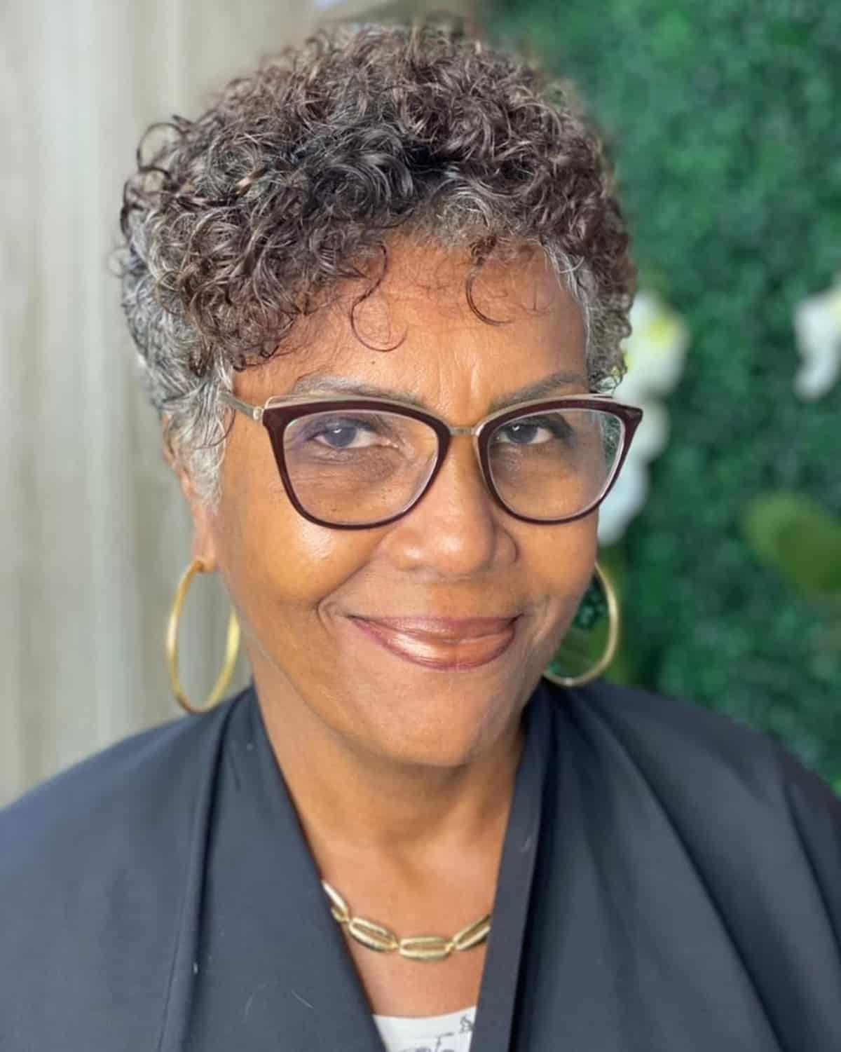 Stylish curly pixie cut with glasses for an older woman