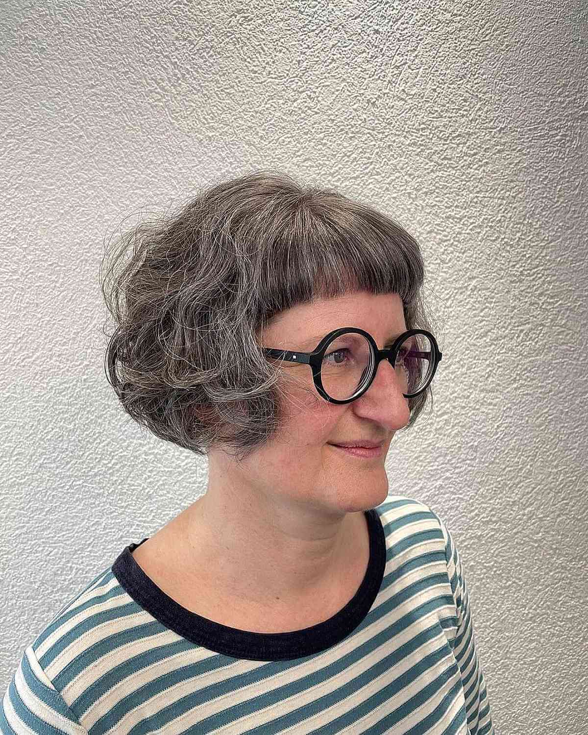 Chic Ear-Length Tousled Cut with Short Bangs for 60-Year-Old Women