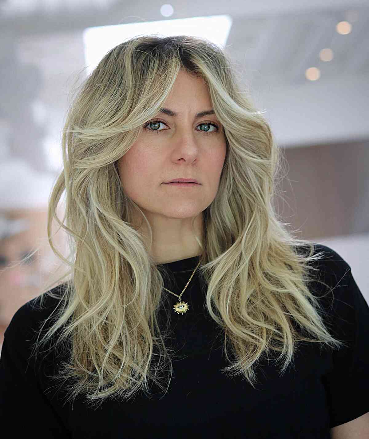Stylish Face-Framing Tousled Blonde Shag for Women Over 40 with Mid-Long Hair