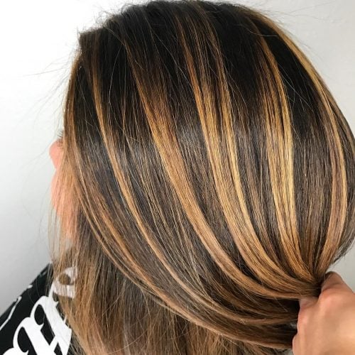 Chic Golden Accents on Dark Hair