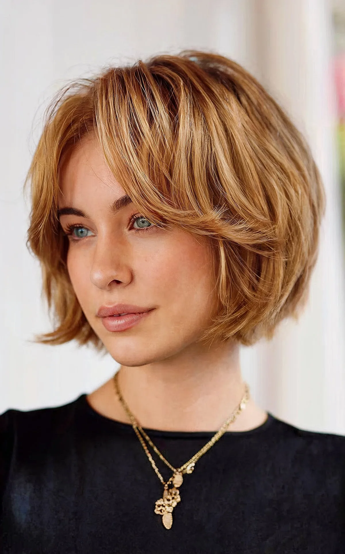 Chic Golden Brown Layers on a Bob Haircut with Bangs