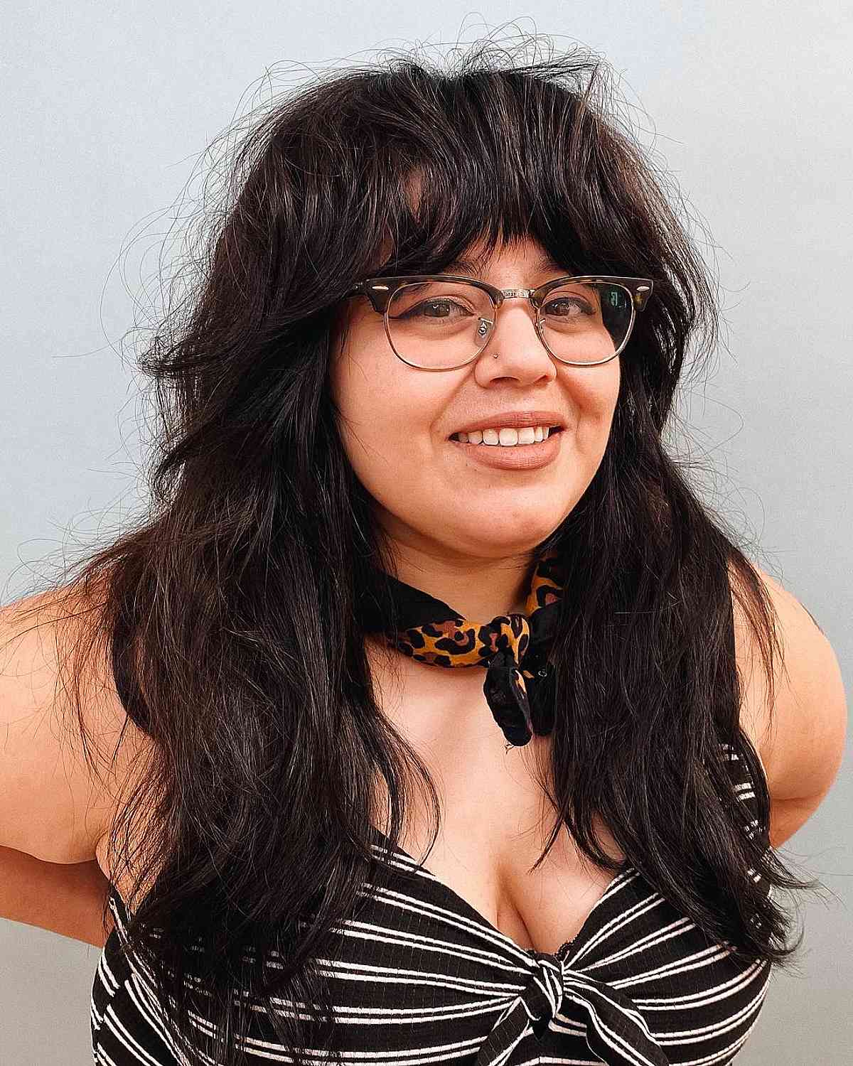 Chic Layers and Full Bangs for Round Faces