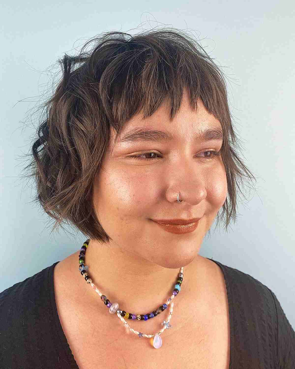 Chic Messy Bob with Textured Bangs for Round Faces