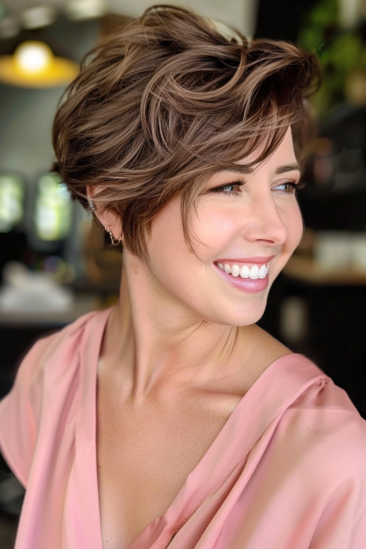Stylish tousled wavy pixie bob featuring an undercut for an elegant yet fun appearance.