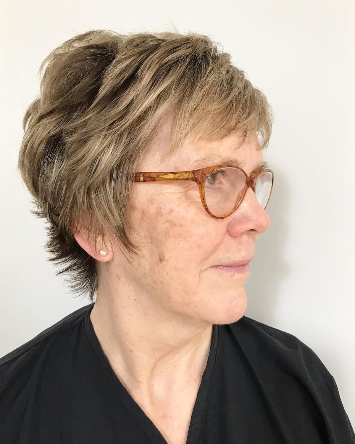 Stylish pixie hairstyle for women over 70 with glasses