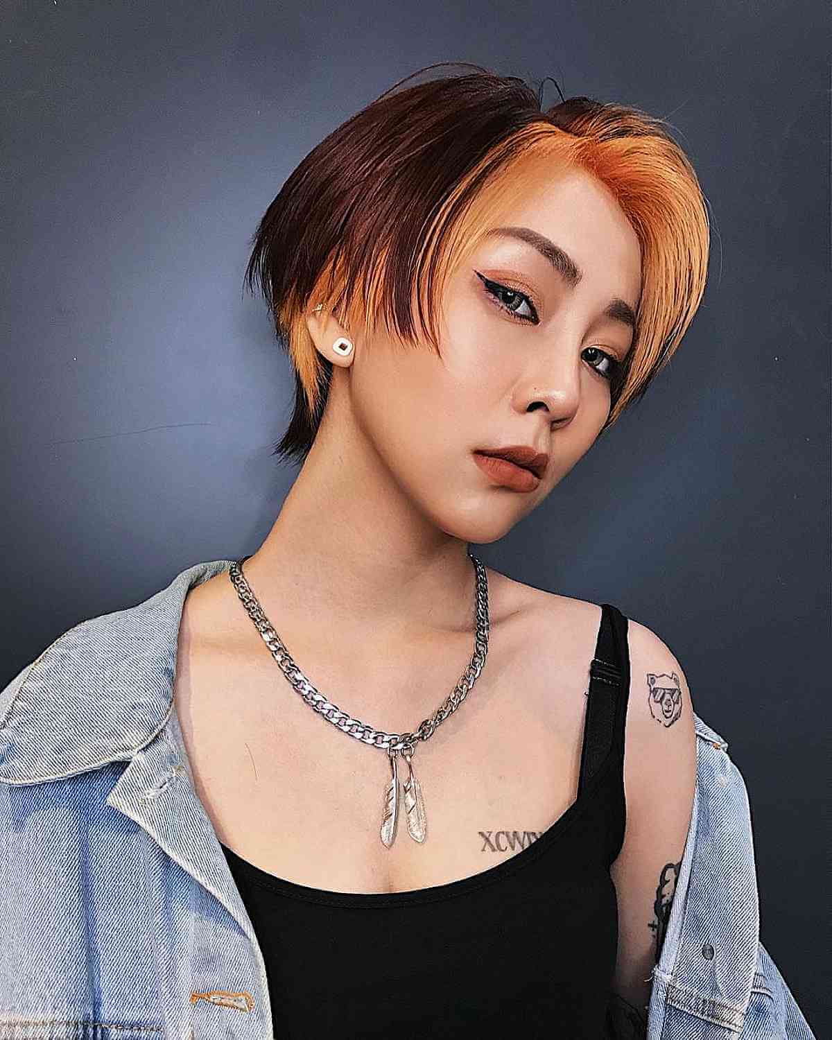 Ear-Length Chic Pixie Mullet with a Vibrant Orange Money Piece