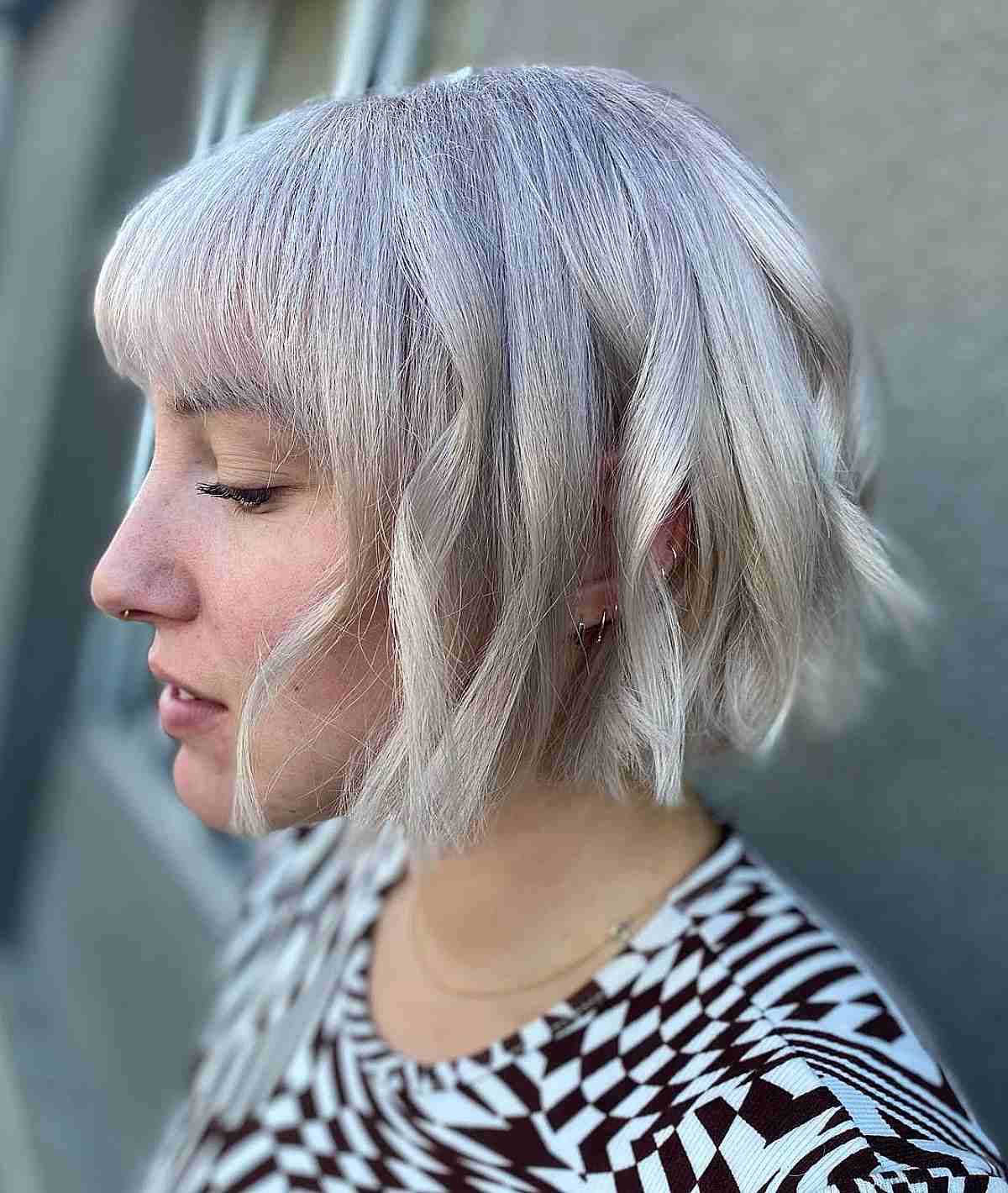 Chic Platinum Bob with Bangs on Thick Chin-Length Hair