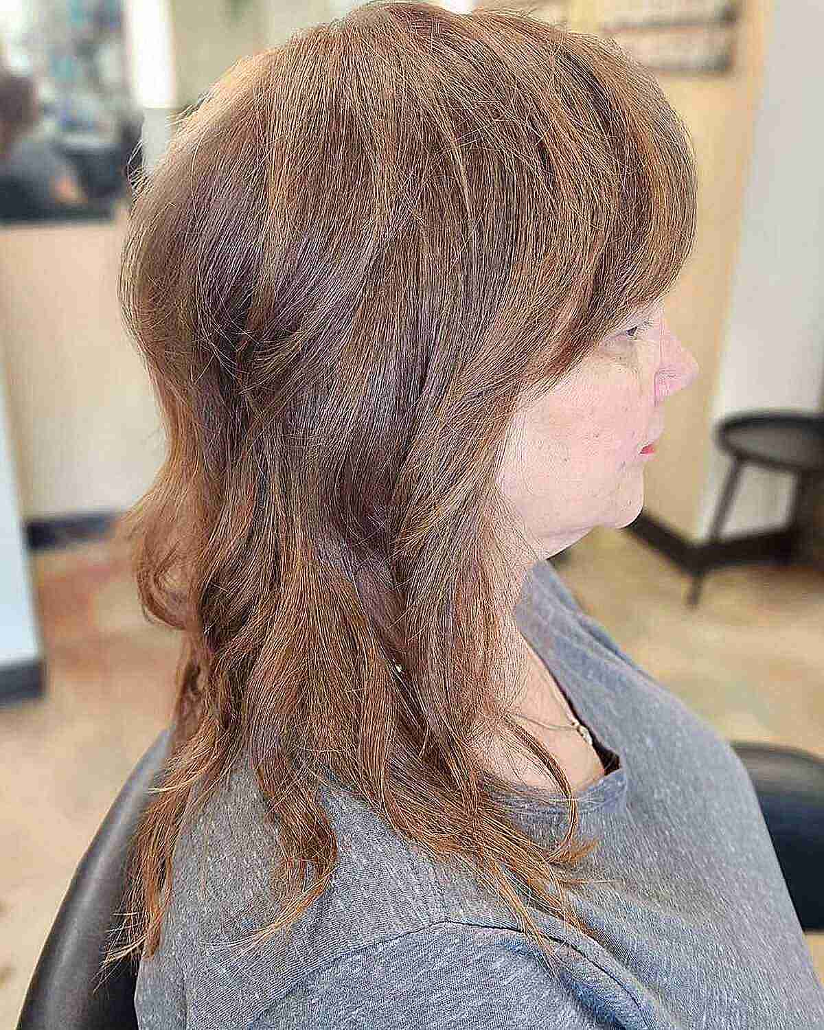Mid-Length Chic Retro Shag with Dense Layers and Bangs for Older Women