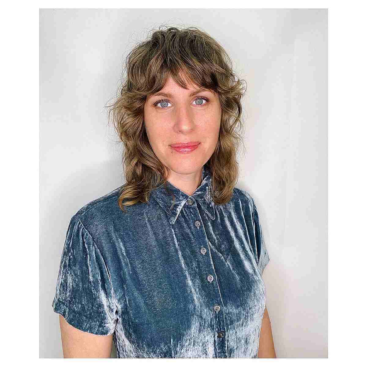 Medium-Length Shag Cut with Gentle Curls and Fringe for Women Over 40