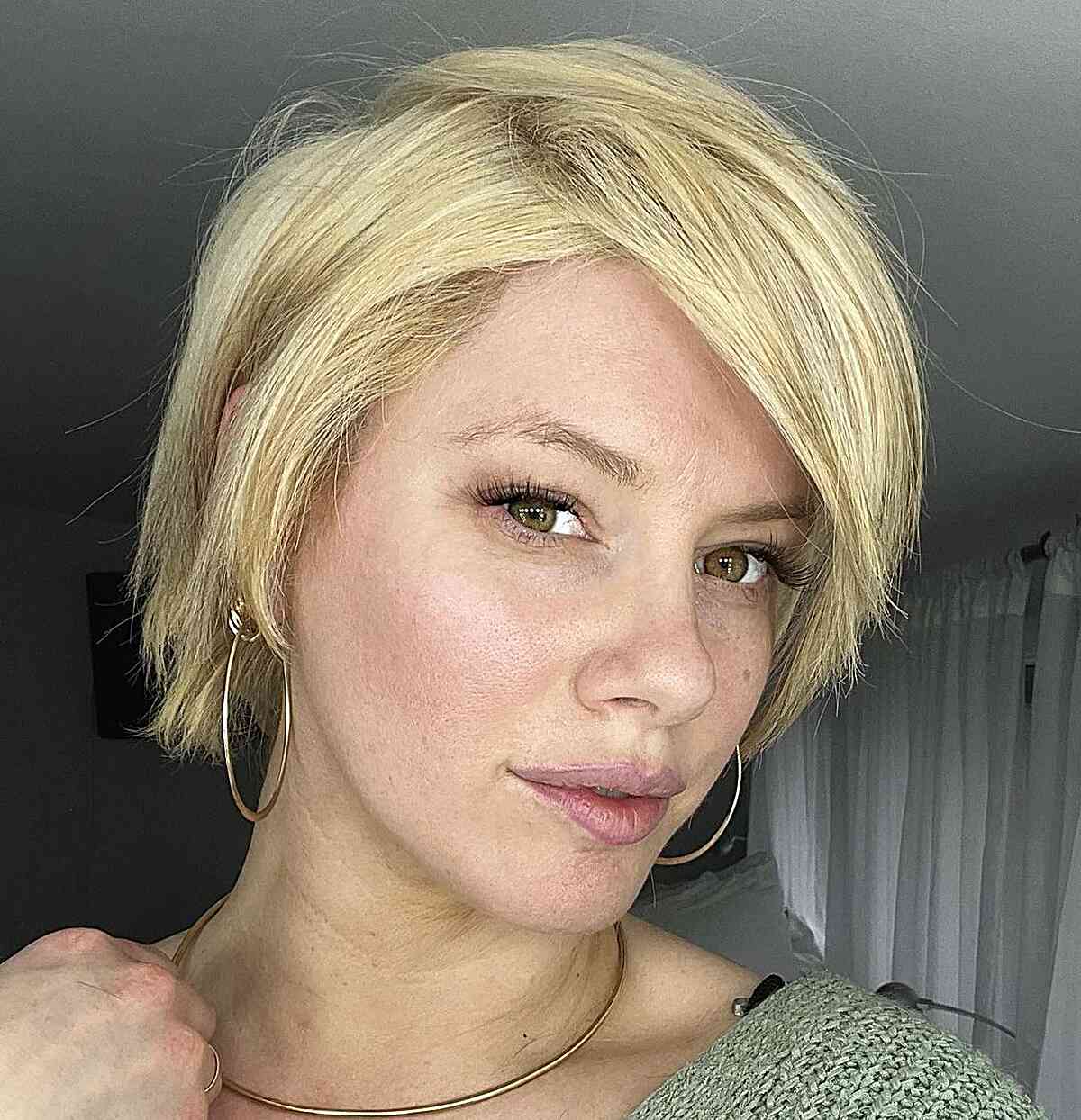 Stylish short blonde hair featuring long bangs