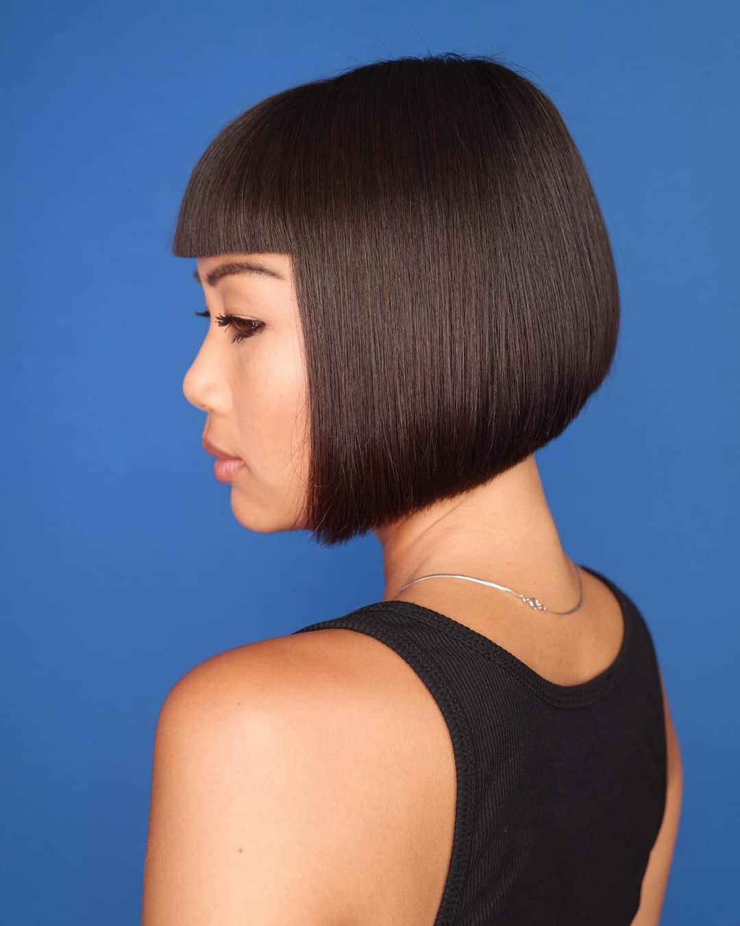 Chic short hairstyle featuring blunt bangs for asian girl