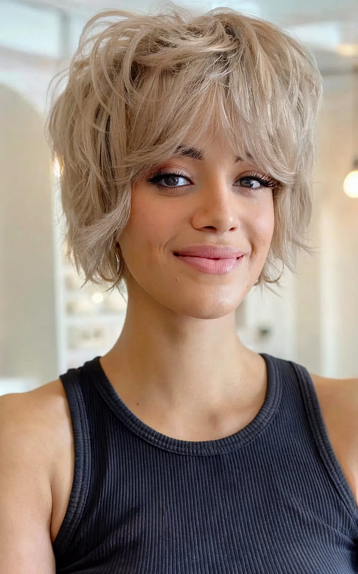 Chic Short Shag with Volume and Bangs on Blonde Hair