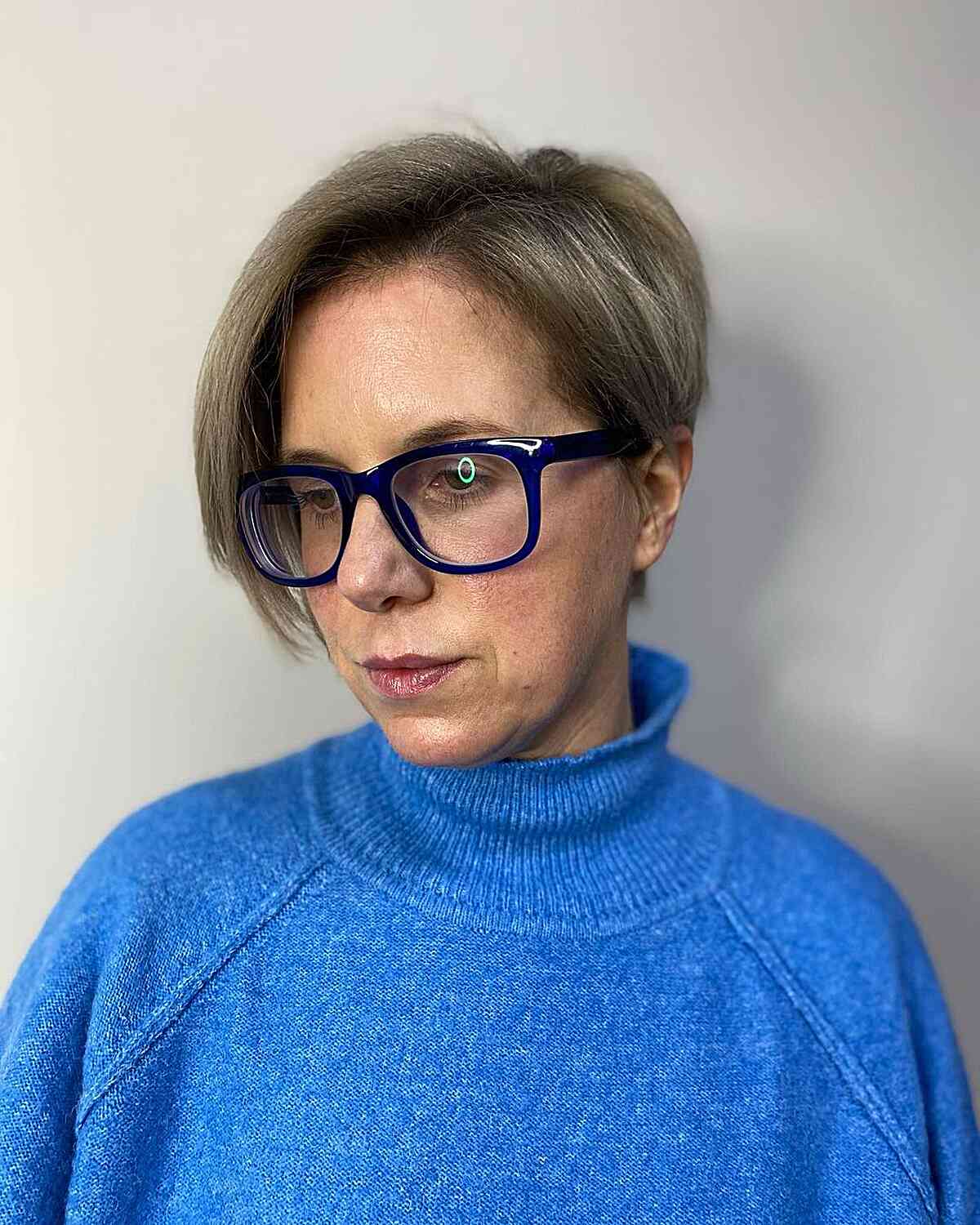 Stylish Short-Length Side Part Pixie Bob with Extended Bangs on Mature Ladies Donning Glasses