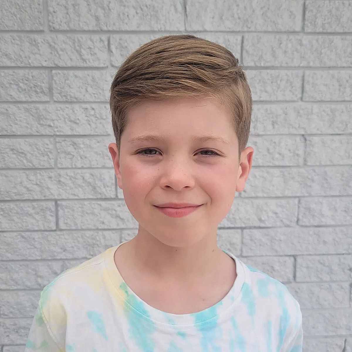 Chic Side Swept Blonde Hairstyle for Young Boys