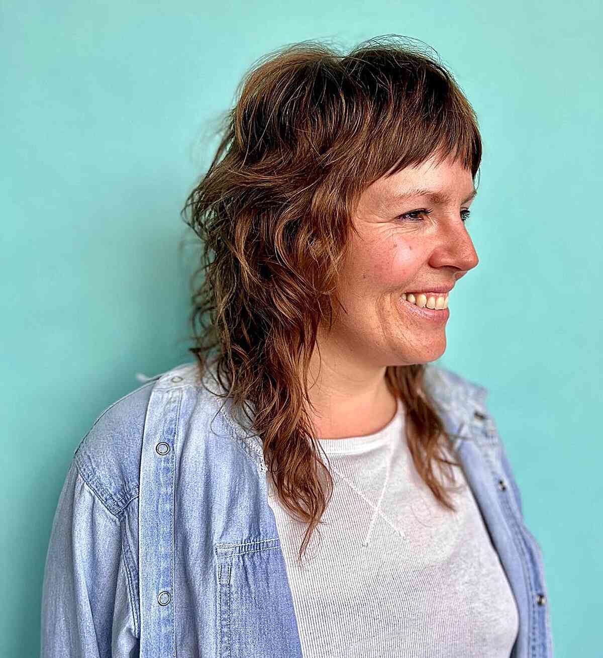 Stylish Mid-Length Textured Shag with Short Bangs for Women Over 40