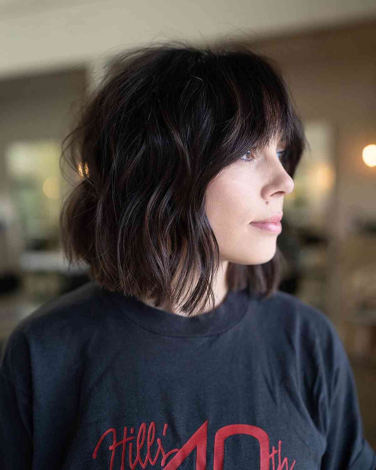 Chic Wavy Hairstyle with Brow-Skimming Bangs