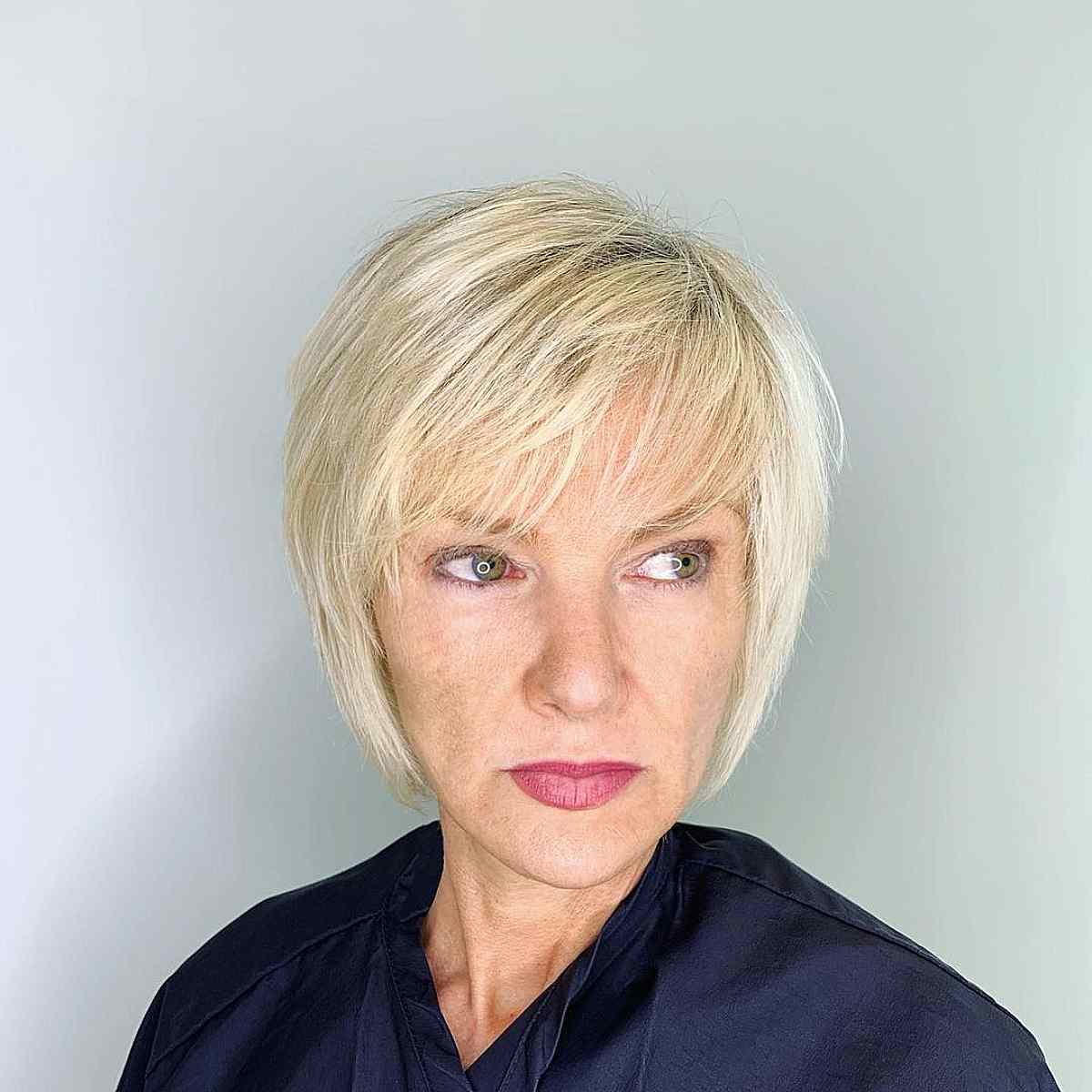 Chic Wispy Blonde Bob with Side-Swept Bangs for Women Over 40