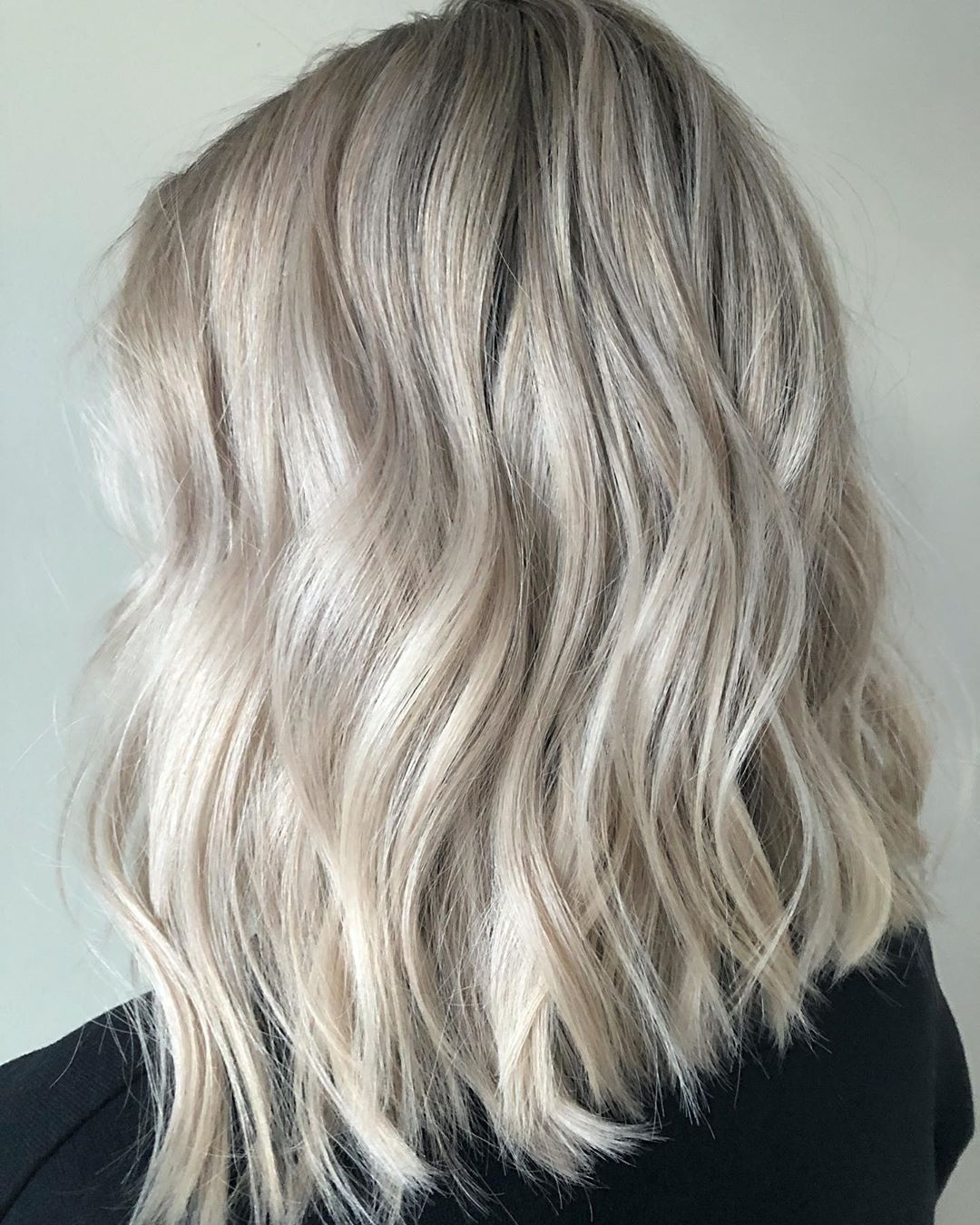 Chilly Blonde Shade on Mid-Length Hair with Effortless Beach Waves