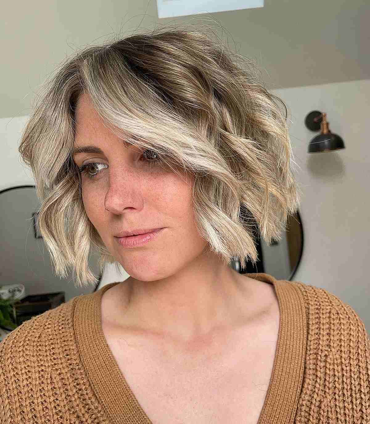 Choppy Chin-Length Bob with Blonde Balayage and Waves