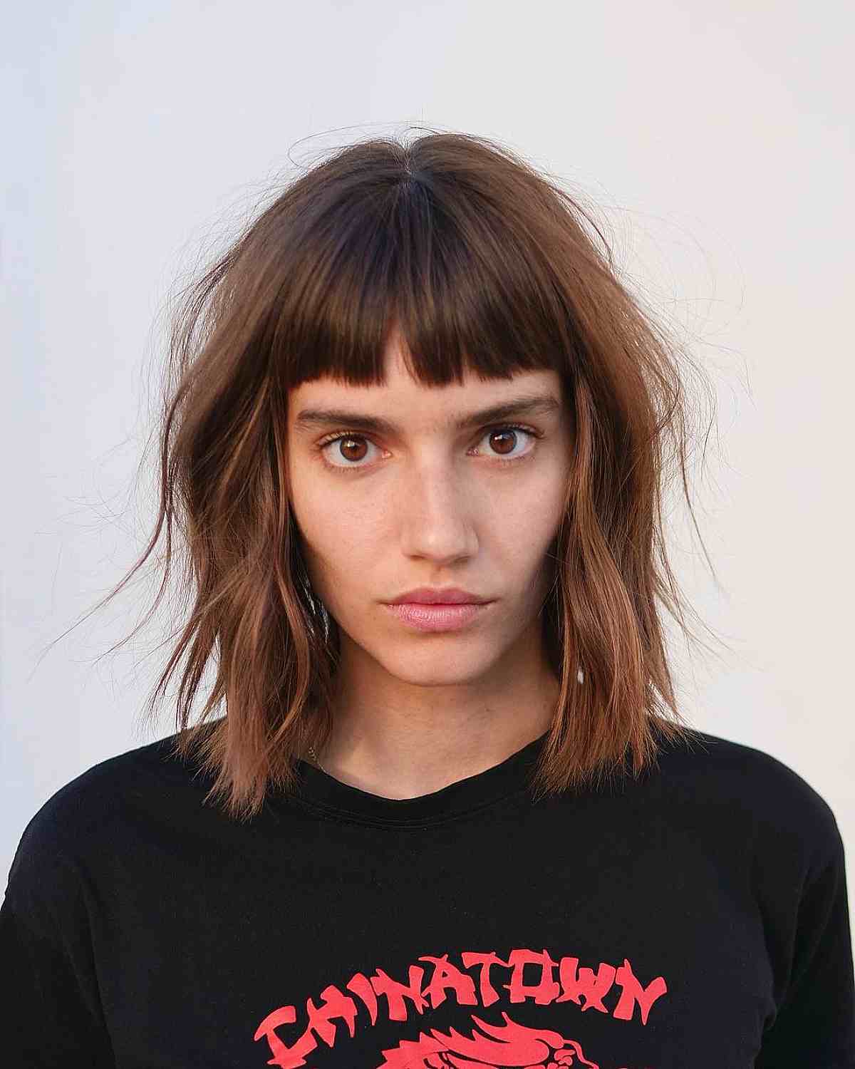 Medium Bob featuring Choppy Wispy Layers and Short Bangs