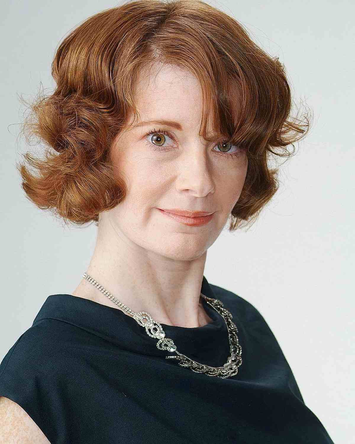 Classic Short Auburn Bob Hairstyle with Bangs