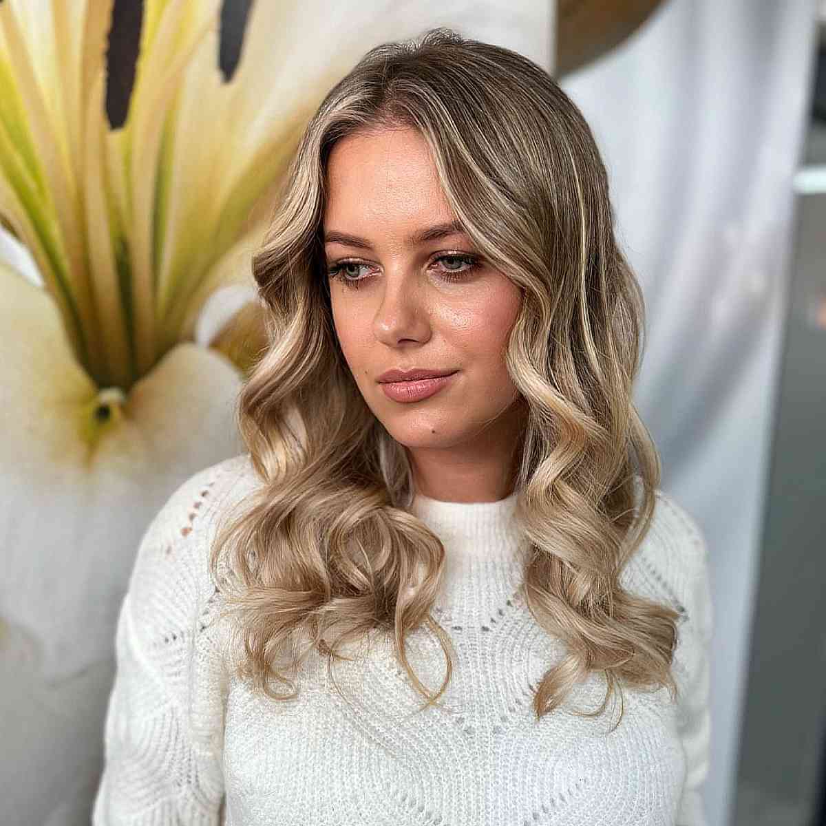 Contemporary Blonde Balayage on Effortlessly Wavy Locks